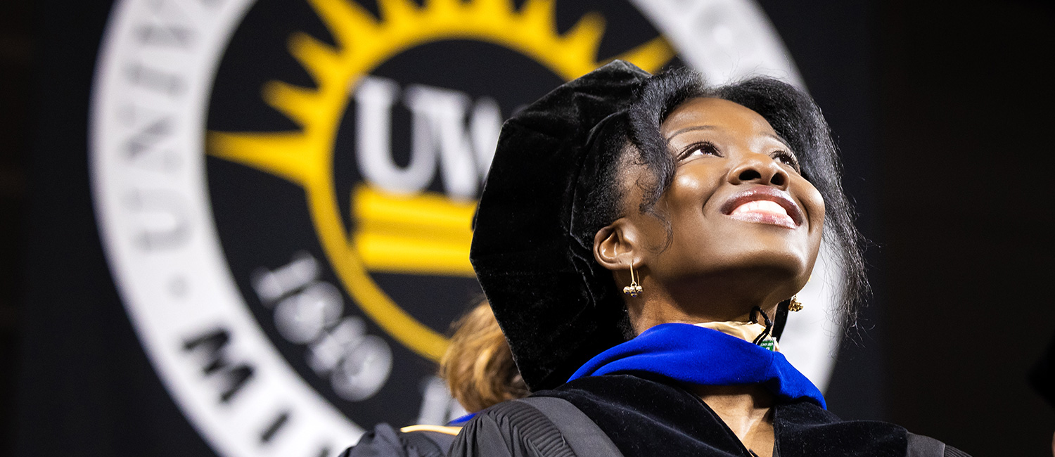 Black female PhD student smiling at UWM graduation