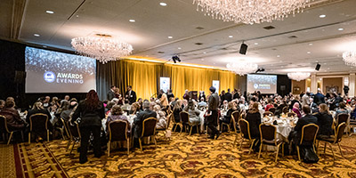 2022 Alumni Awardees pose on stage with UWM leadership members.