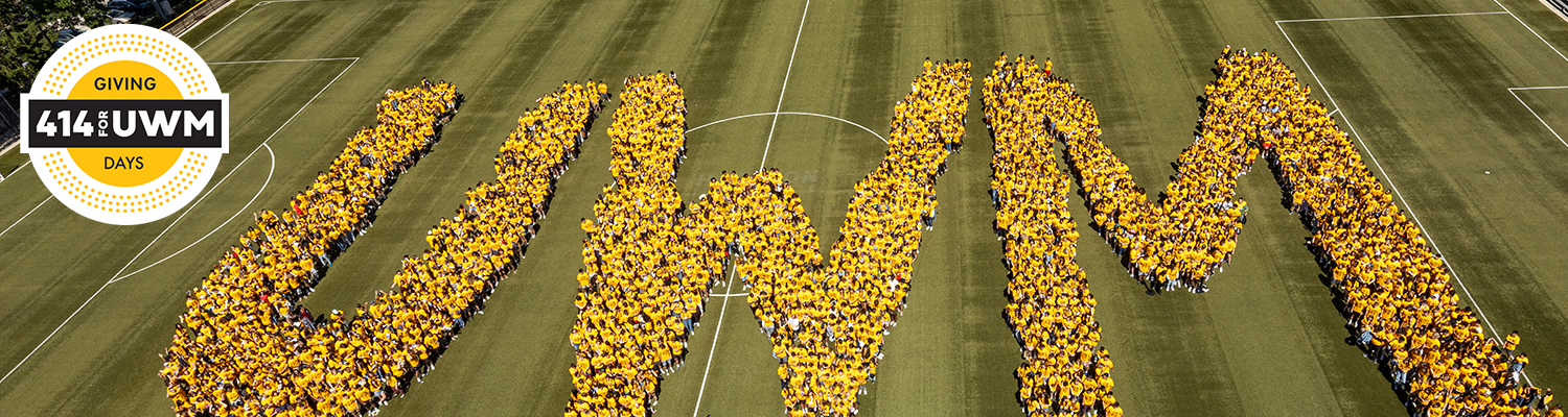 UWM students line up on Engelman Field to spell out the letters UWM.