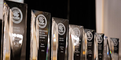 Alumni Awards are displayed on a table.