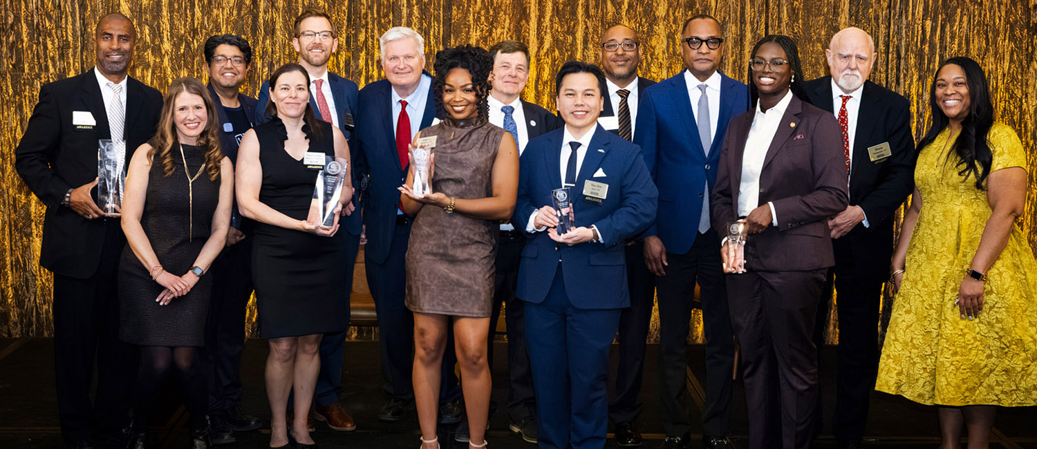 2026 Awardees pose on stage
