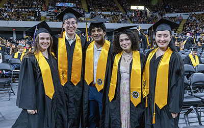 Graduates pose for a photo at graduation