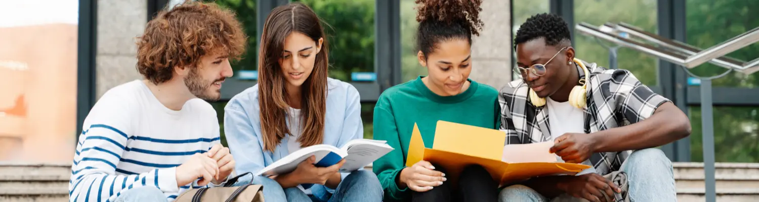 students looking at open books together