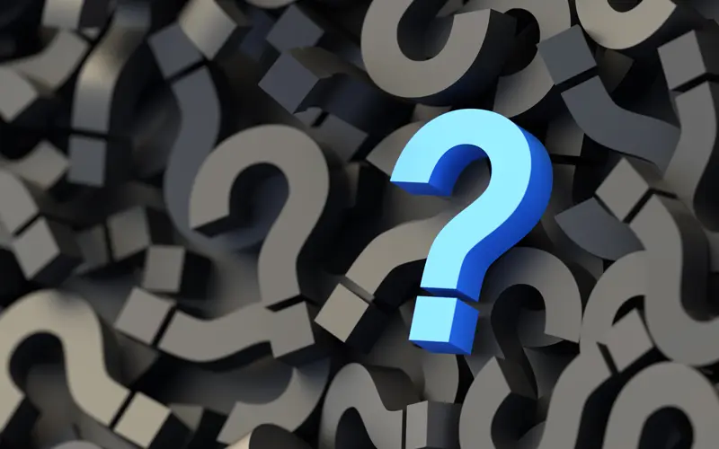 Blue question mark on a field of black question marks