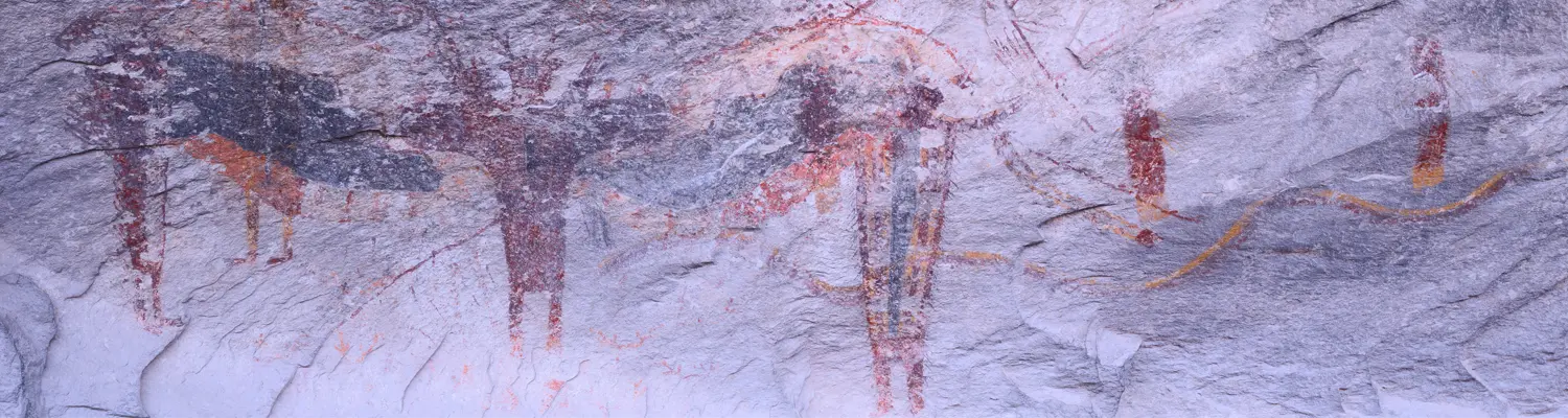 crude drawings on cave wall