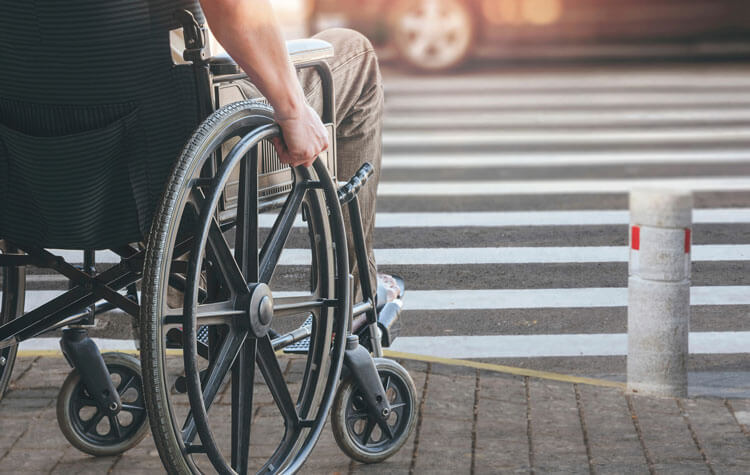 Man in wheelchair at crosswalk