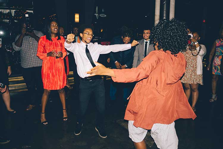 Architecture students dance at a social event.