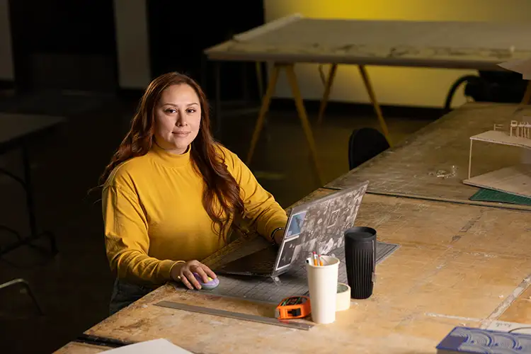 UWM student Dulce Carreno sits with her laptop open in front of her