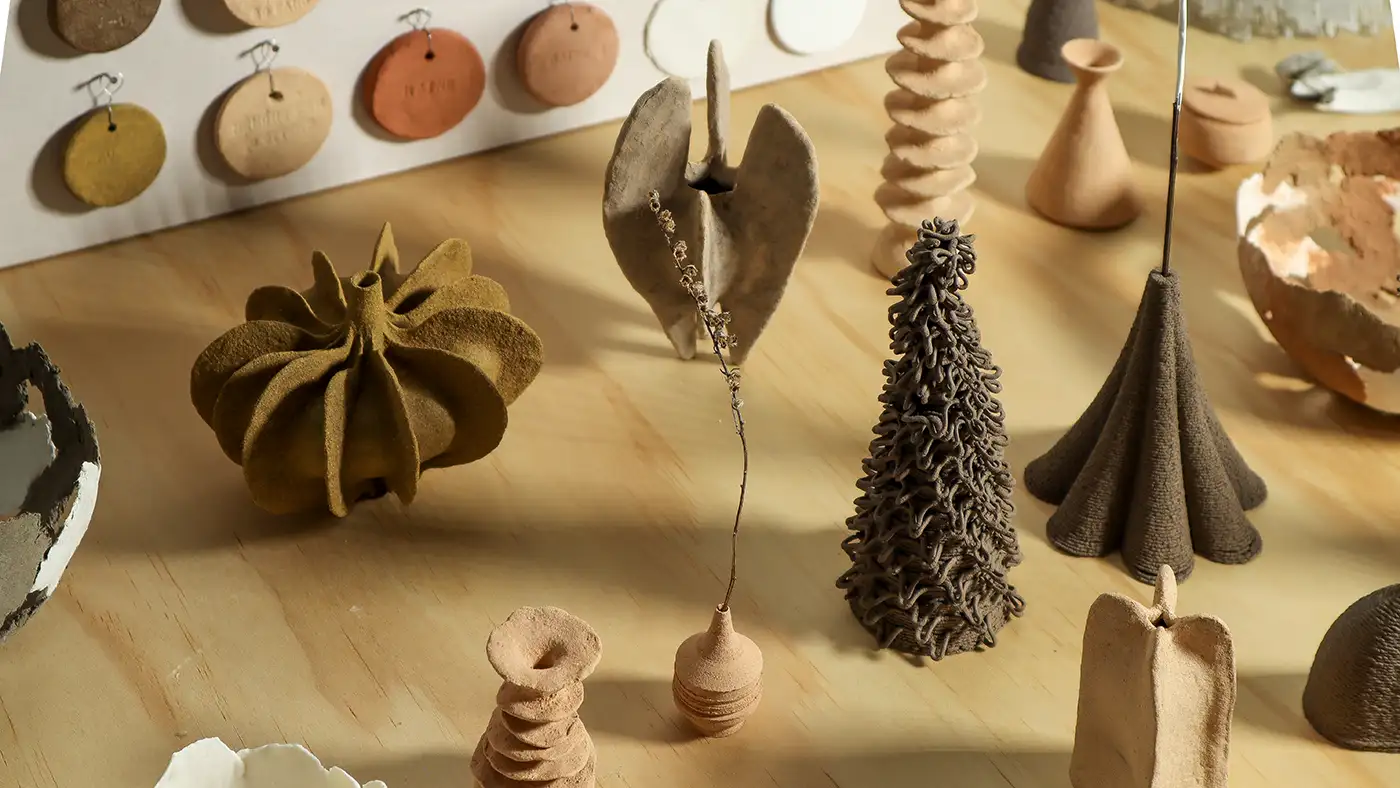 Ceramics in earth tones are displayed as examples of work by Iris Xiaoxue Ma.