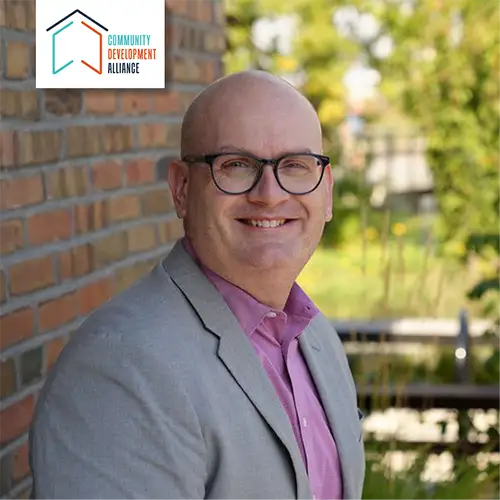 Teig headshot with Community Development Alliance logo