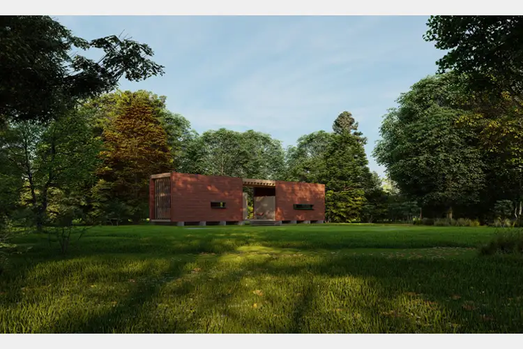 Two rust-colored rectangular buildings sit in a grassy clearing, surrounded by dense trees under a clear sky, with long sunlit shadows across the lawn. Two rust-colored rectangular buildings sit in a grassy clearing, surrounded by dense trees under a clear sky, with long sunlit shadows across the lawn.