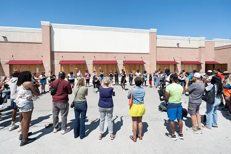 People gathered in the parking lot around the closed Pick n' Save.