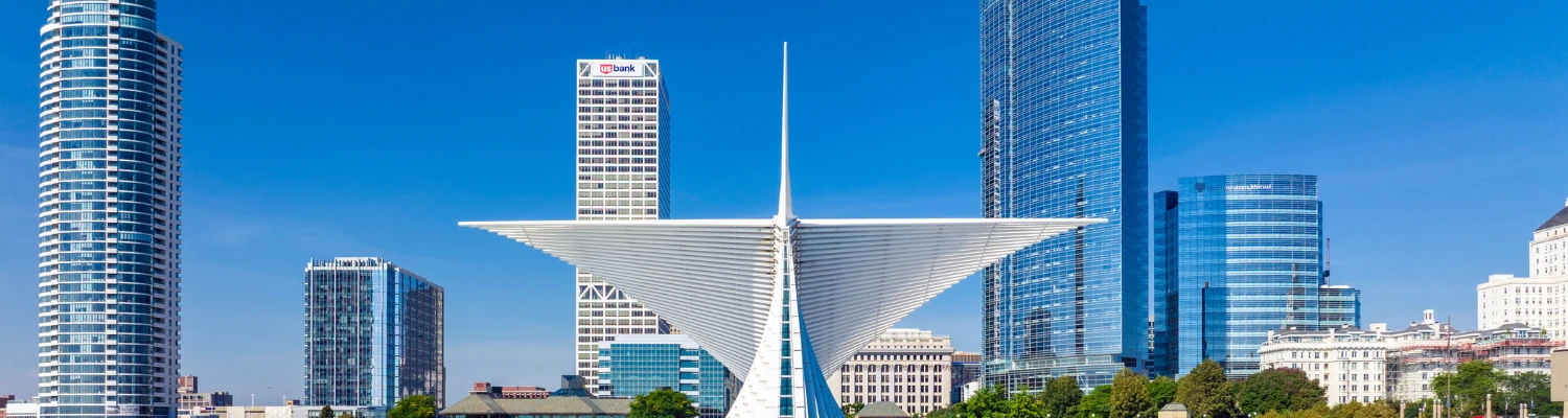 large white abstract building overlooking the city skyline