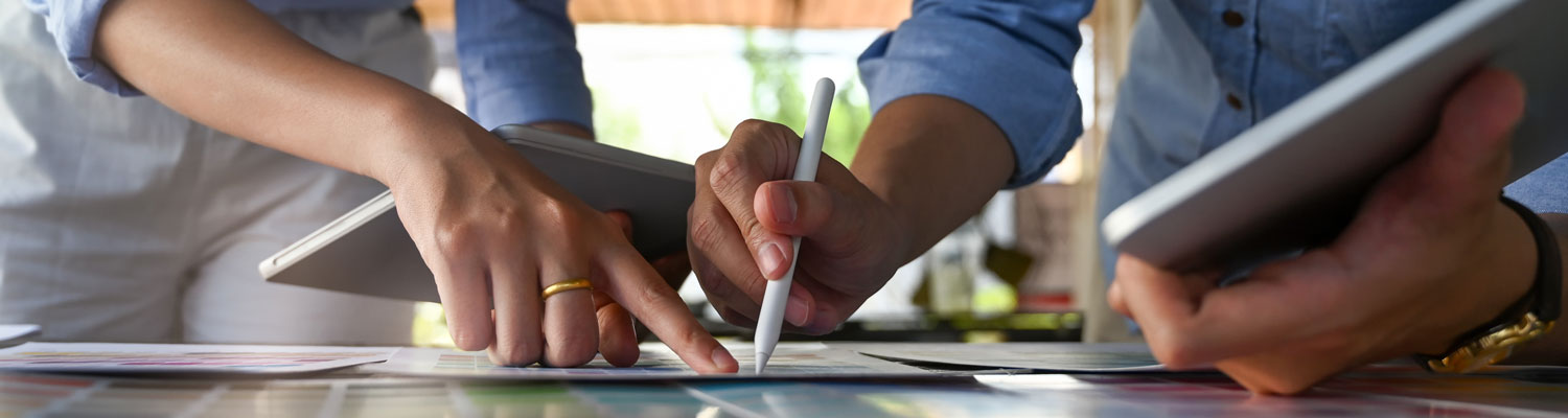 hands pointing to paper