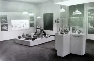 A black-and-white photograph of a museum or exhibition space.