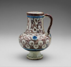 Figure 2. Ewer Inscribed with "al-'izz" ("Glory") in Floriated Kufic on its Neck. Syria (Raqqa), first half of the 13th century CE. Stonepaste with Glaze. Credit Line: HO Havemeyer Collection, Gift of Horace Havemeyer, 1948. Metropolitan Museum of Art, 48.113.18.