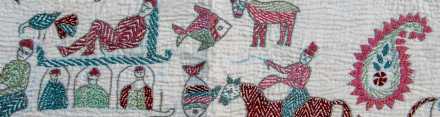 Hand-embroidered textile showing people, animals, and decorative motifs in red, green, and blue thread