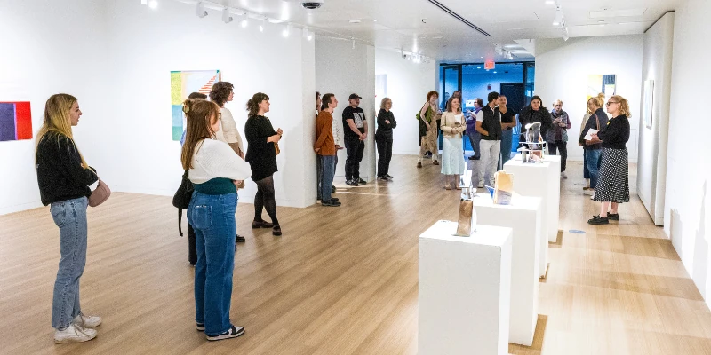 Students gathered at an exhibition in the UWM Art Museum.