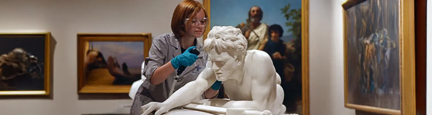 conservator working on sculpture