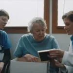 A doctor meets with a patient and one other person.