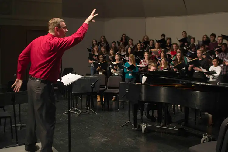 Choral conductor Dr. Zack Durlam leads a large vocal ensemble at the Zelazo Center.