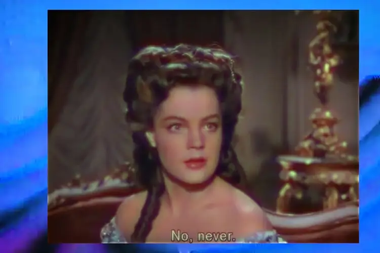 A person in an ornate, off‑the‑shoulder costume sits indoors against a richly decorated background with the subtitle "No, never."