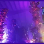 Colorful coral-like sculptures are bathed in purple light.