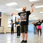 Rich Ashworth leads a room of dancers during a summer intensive for young artists.