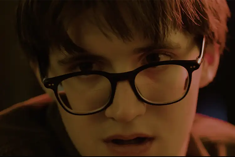 A man looks dramatically to the left while being cast in red and green light A man looks dramatically to the left while being cast in red and green light