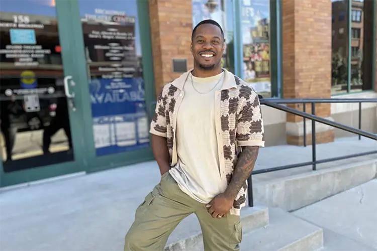 Dimonte Henning stands outside of the Broadway Theatre Center