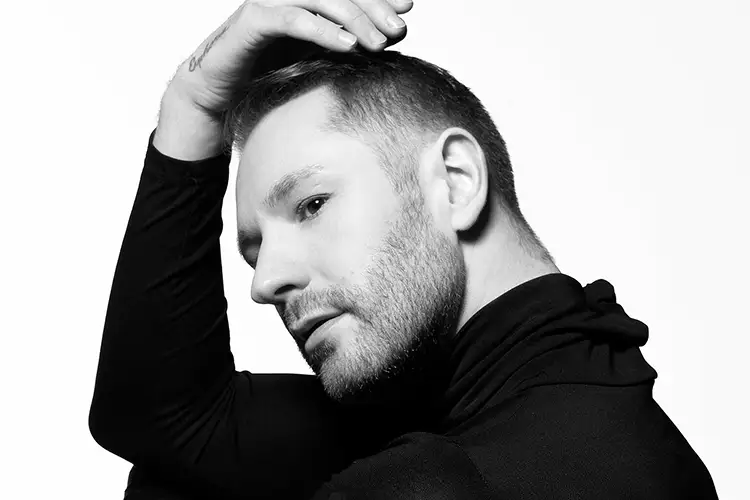 Black and white photo of Alex Hlavaty with hands resting on head.