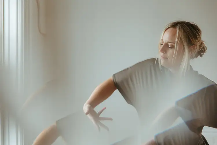 Kelly Anderson poses in a brightly lit room.