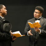 Two students perform in a staged reading.