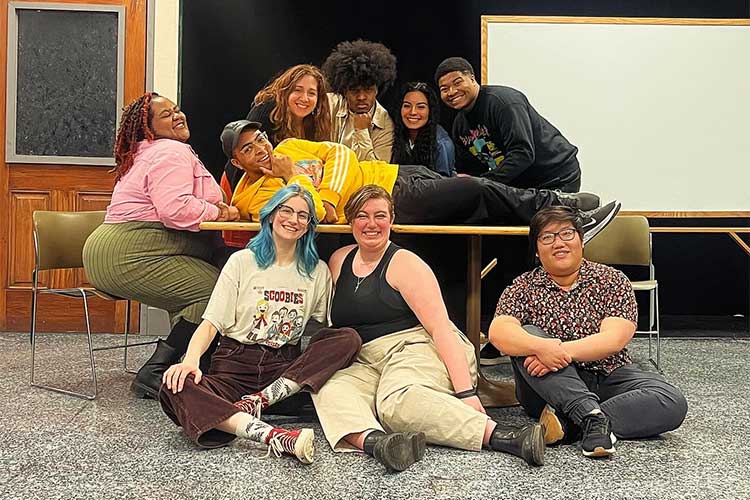 The cast and crew of Pipeline pose for a photo during a rehearsal