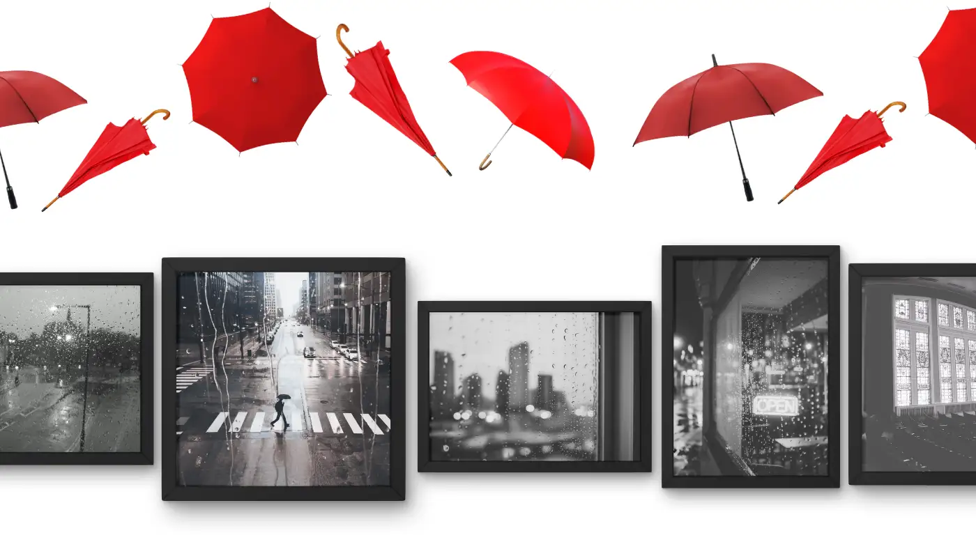Red umbrellas above framed black-and-white photos of rainy city streets.