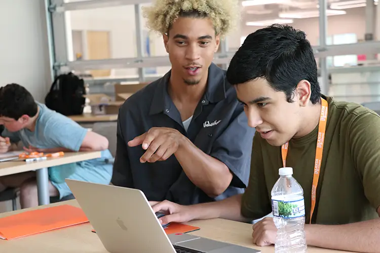 UWM grad student and research assistant Mich Dillon guides a student using Photoshop during an Islands of Brilliance Foundation Workshop. The workshop was part of Study 1 of the ABLE Research lab study.