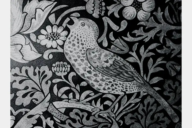 Black and white fresco of a stylized bird with leaves and flowers around it