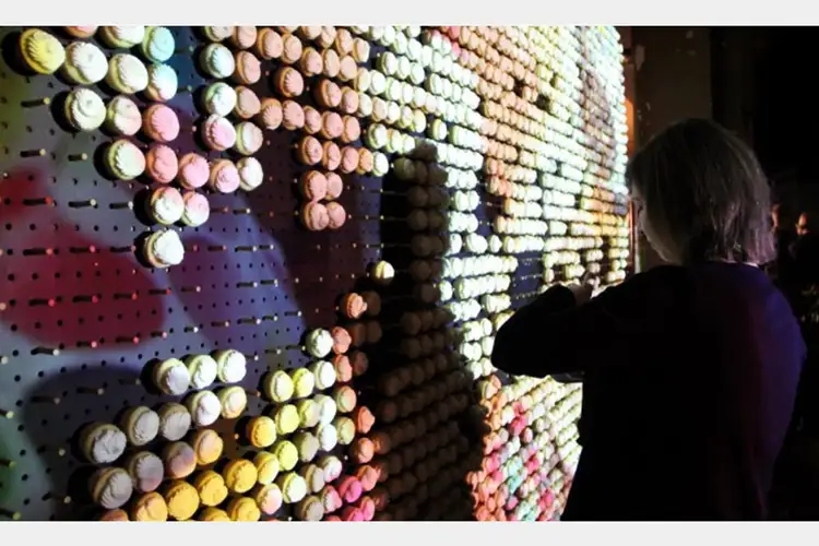 a woman in front of cookies lit and placed on a wall a woman in front of cookies lit and placed on a wall