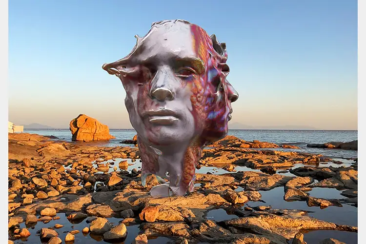 Two digital merged heads in gray and pink over rocks on the shores of a lake or ocean Two digital merged heads in gray and pink over rocks on the shores of a lake or ocean