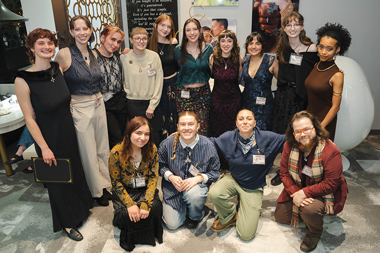 Kesslers internship participants stand around smiling for a group photo.