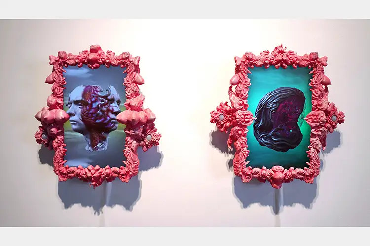 Screens displaying two heads merged together (left) and a rotated brain (right) with pink, flesh-like frames Screens displaying two heads merged together (left) and a rotated brain (right) with pink, flesh-like frames