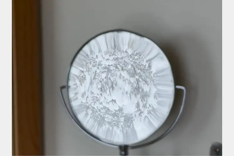 Distorted reflection of a snowy outdoors in a standing detail mirror