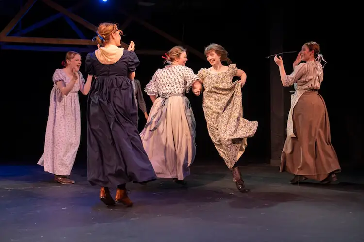 Women dance on stage in historical clothing. Women dance on stage in historical clothing.