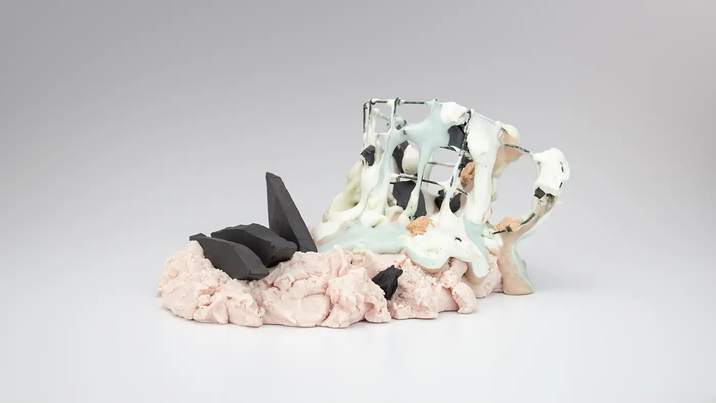 Abstract mixed-media sculpture featuring black geometric forms and pale flowing structures on a textured base.
