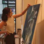 Bradfish paints on a canvas.