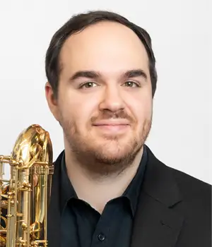 Headshot of Brian Kachur holding a saxophone.