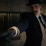 A still from Never Fell in Love by Tommy Simms. A mustached man in a nice suit aims a gun.