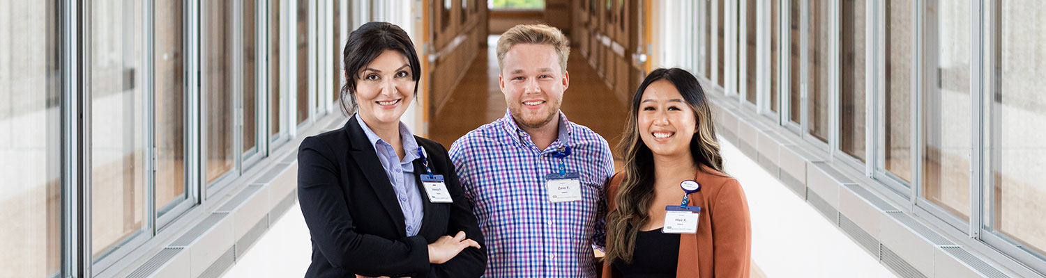 Three future health care administrators standing in a hallway