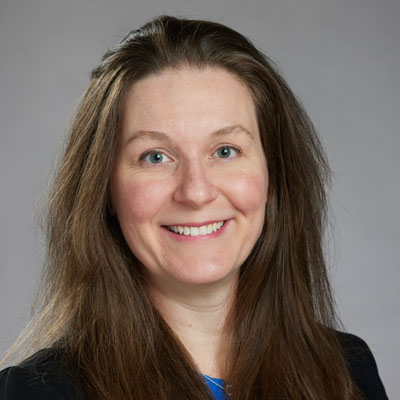 Pamela Bermender headshot on gray background.