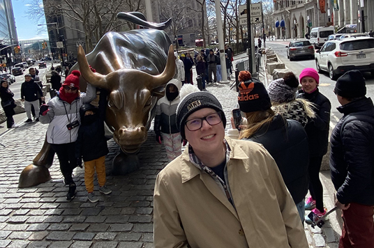 UWM Students outside of the New York Stock Exchange with the famous Wall Street Bull Statue.